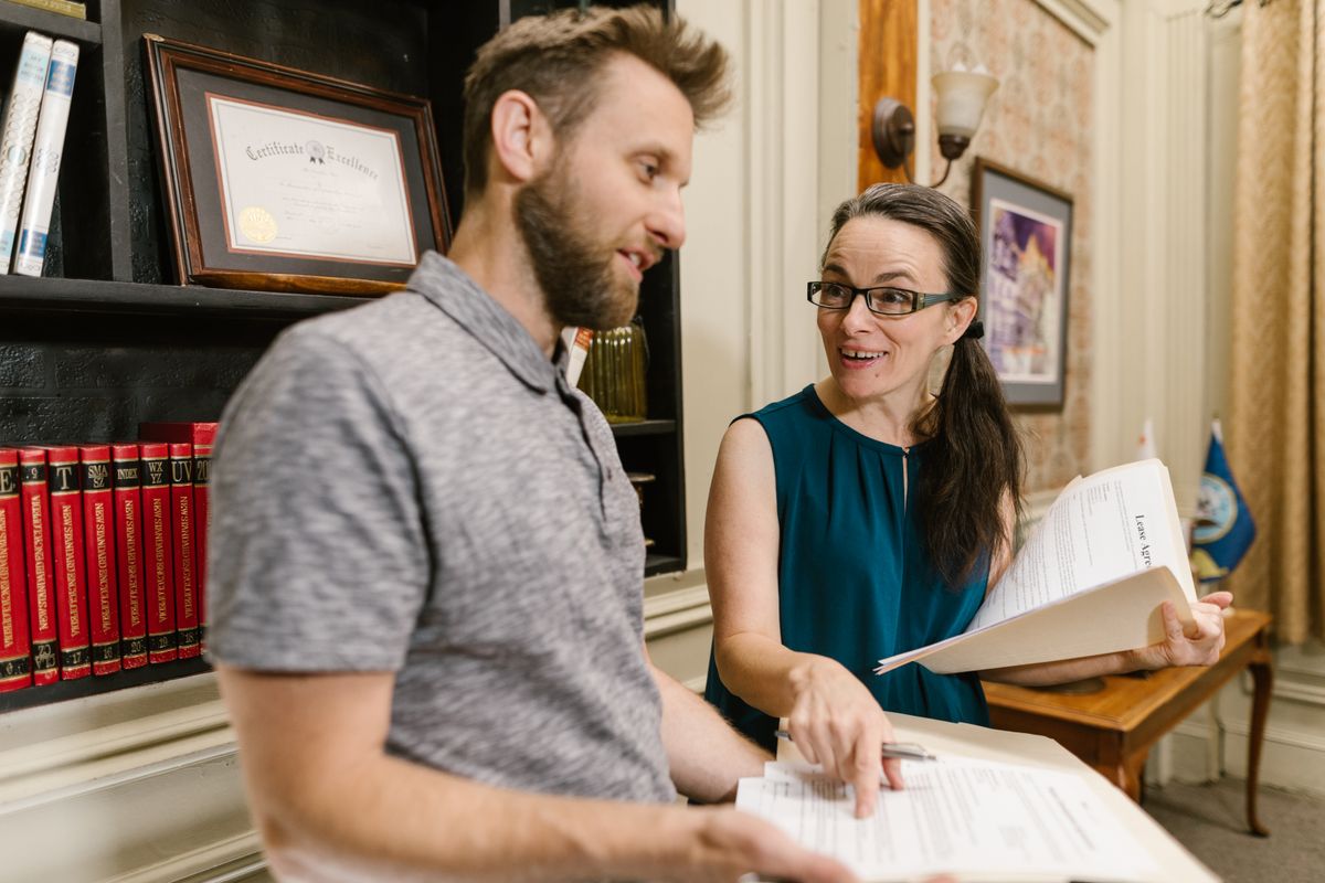 Consultant reviewing property documents with clients